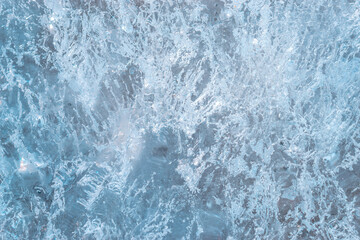 Blue background with white specks and a blue and white pattern. The background is a reflection of the sky