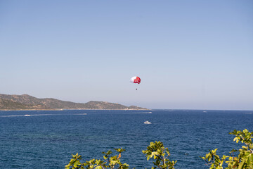 Experience thrilling parasailing over vast blue waters and distant hills, creating unforgettable...