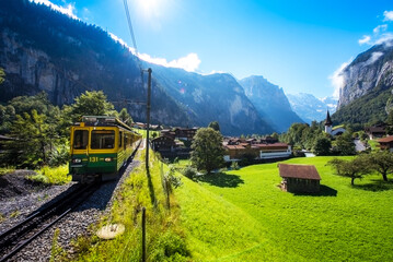 Beautiful mountain landscape with train in canyon of the city Lauterbrunnen in the Swiss Alps, Switzerland. Amazing places.