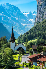 The Incredible picturesque landscape in Lauterbrunnen with canyon, church and famous Staubbach...