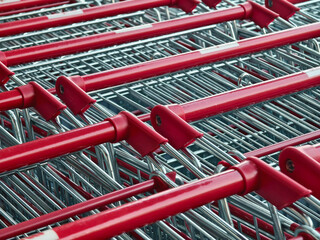A row of shopping carts is neatly lined up in a straight row