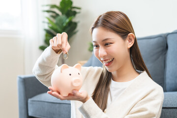 Financial, asian young woman, girl putting stack coins on table for calculate cost sitting in...