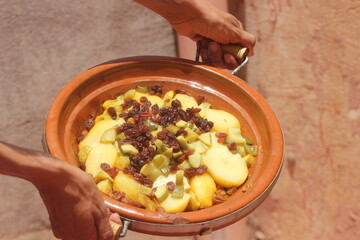 Hands Holding a Fresh Moroccan Tajine