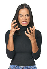 Simple portrait of a young Latina upset screaming with tense hands.