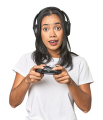 Latina gamer using a controller in studio