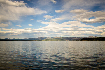 Fototapeta premium Panoramic View of Mountain Lake with Light and Shadow on Surrounding Hills – Yellowstone Panorama 