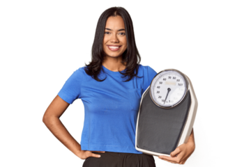 Filipino woman with scale in studio showing a copy space on a palm and holding another hand on waist.