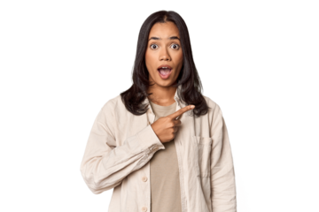 Portrait of a young Filipino woman pointing to the side