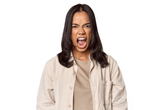 Portrait of a young Filipino woman screaming very angry and aggressive. - Powered by Adobe