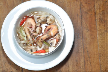 Dive into a vibrant bowl of shrimp soup, brimming with fresh prawns, mushrooms, and aromatic herbs....
