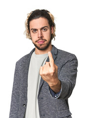 Young businessman in casual blazer pointing with finger at you as if inviting come closer.