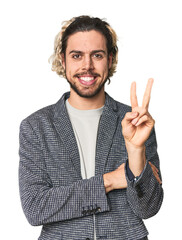 Young businessman in casual blazer showing number two with fingers.