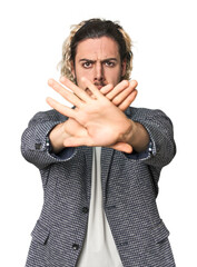 Young businessman in casual blazer doing a denial gesture