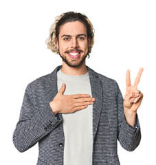 Young businessman in casual blazer taking an oath, putting hand on chest.