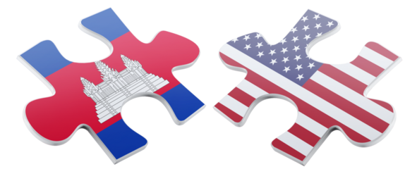 Two jigsaw puzzle pieces featuring the Cambodian flag on one side and the United States flag on the other, symbolizing connection and cooperation on a glossy black background.