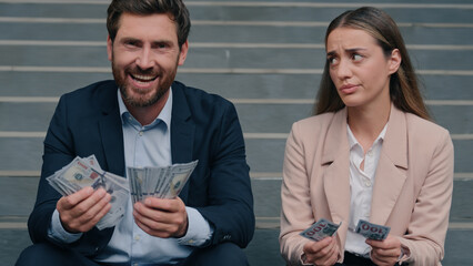Caucasian colleagues man woman count money salary business financial inequality envy offended...