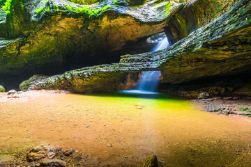 Picturesque underground waterfall Saltinsky and lake in the Caucasus Mountains. Dagestan