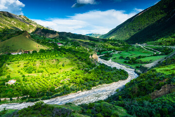Picturesque mountain landscape with a winding mountain river and fruit gardens. Dagestan, Caucasus