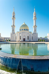 Beautiful view of white mosque with reflection in water. Russia