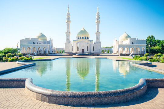Beautiful view of white mosque with reflection in water. Russia