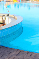 Empty bar counter of the swimming pool with clear azure water