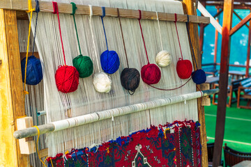 Balls of thread on a primitive loom for handicrafts