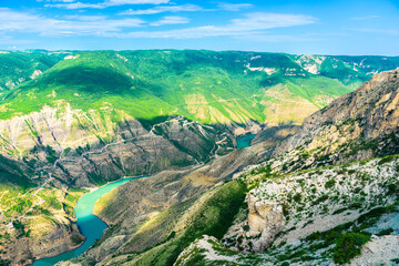 Panoramic landscape of a deep picturesque canyon of the Caucasian mountains of Dagestan and the azure mountain river Sulak. Russia