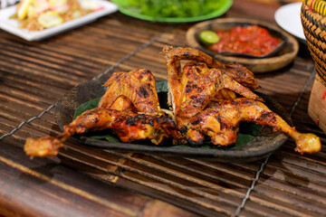 a grilled chicken on a wooden plate