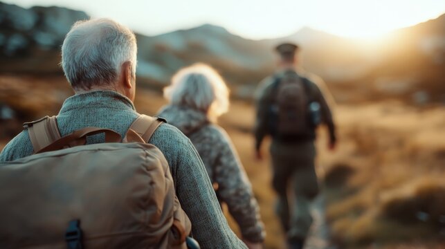 Two elderly hikers traverse a scenic mountain pathway at sunset, capturing the spirit of adventure and resilience while surrounded by nature's beauty and tranquility.