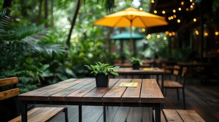 A beautifully arranged outdoor cafe table with potted plants and an umbrella, inviting relaxation and enjoyment in a serene natural setting for visitors.