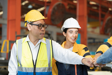 Workers, teamwork and cooperation. Workers join their hands together in industry factory. Unity and teamwork concept