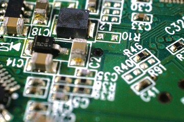 Close-up shot of a circuit board's intricate components and pathways.  Green PCB texture and...