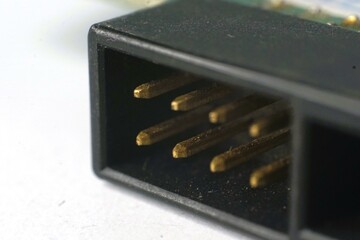 Close-up macro shot of gold pins in a black connector.  Perfect for tech, electronics, and hardware...