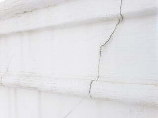 Close-up of a crack in white painted wood.  Perfect for textures, backgrounds, and design projects.