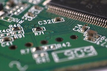 Close-up of a circuit board's intricate details, showcasing its components and connections. Ideal...