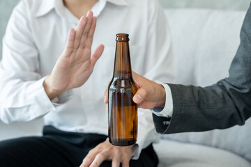 Obraz na płótnie Canvas refuses say no and avoid to drink an alcohol, hand show reject and stopping, alcoholism treatment, alcohol addiction, quit booze, Stop Drinking Alcohol. Refuse bottle liquor, unhealthy