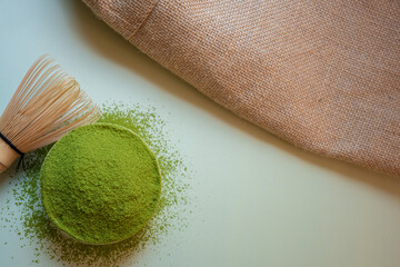 The Matcha green tea on a pastel green background, shot in still life style.