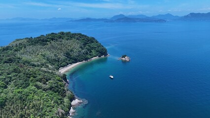 Fototapeta premium Aerial view of a boat floating in the calm blue waters of the Seto Inland Sea, Japan 