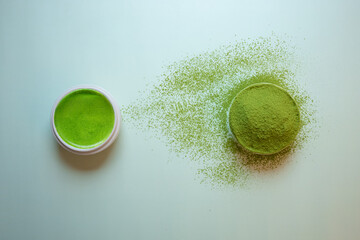 The Matcha green tea on a pastel green background, shot in still life style.