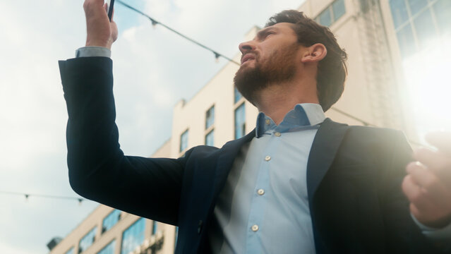 Middle-aged Caucasian business man confused with mobile phone lost signal Wi-Fi connection problem in city frustrated businessman male outside office holding smartphone searching connect online fail