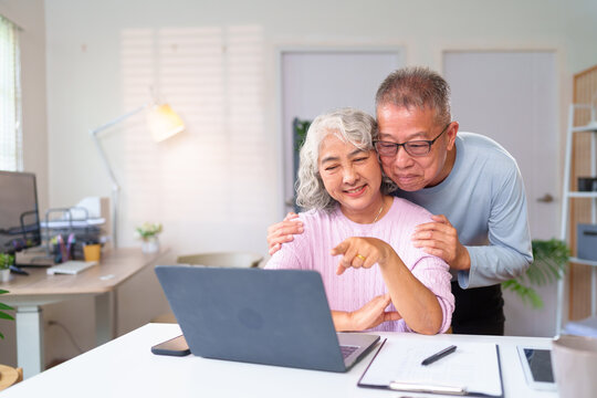 Asian Senior Couple Using Laptop at Home Together Happy Elderly Lifestyle with Online Shopping Banking Video Call Communication
