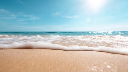A serene beach view showcasing gentle waves caressing the shore under a clear blue sky, illuminated by the warm sunlight, creating a peaceful atmosphere ideal for relaxation.