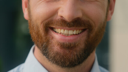 Fototapeta premium Close up cropped view Caucasian half face mouth lips smiling toothy unrecognizable European bristle bearded man smile white tooth healthy dental oral medicine businessman guy male business in city