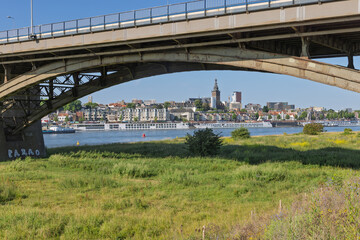 Viewed from beneath the Waalbrug, the picturesque Nijmegen skyline rises across the river,...