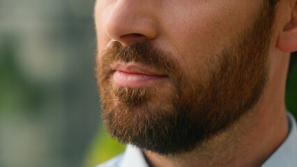 Close up cropped view Caucasian half face mouth lips calm serious unrecognizable European bristle...