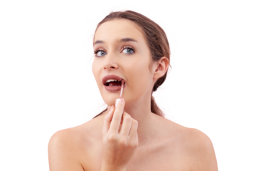 Young woman applying lipstick on her lips with a lip brush applicator as part of her makeup routine. Smooth, flawless complexion. Beauty concept, isolated on white background, looking into camera