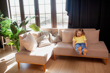 A 7-year-old children boy and girls  in glasses  poses in the sofa indoor