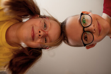 A 7-year-old children boy and girls  in glasses indoor
