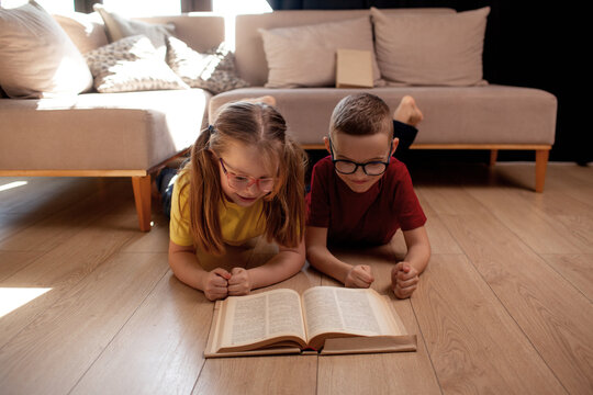 A 7-year-old children boy and girls  in glasses  poses in the sofa indoor