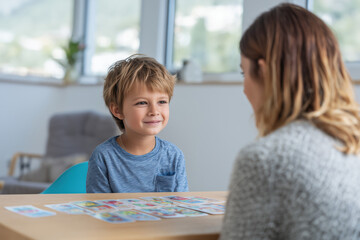 a young kid talking to a therapist / education professional